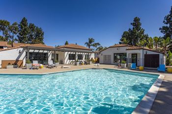 A swimming pool with a house in the background